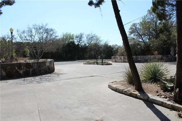 a view of swimming pool with a patio and lake view