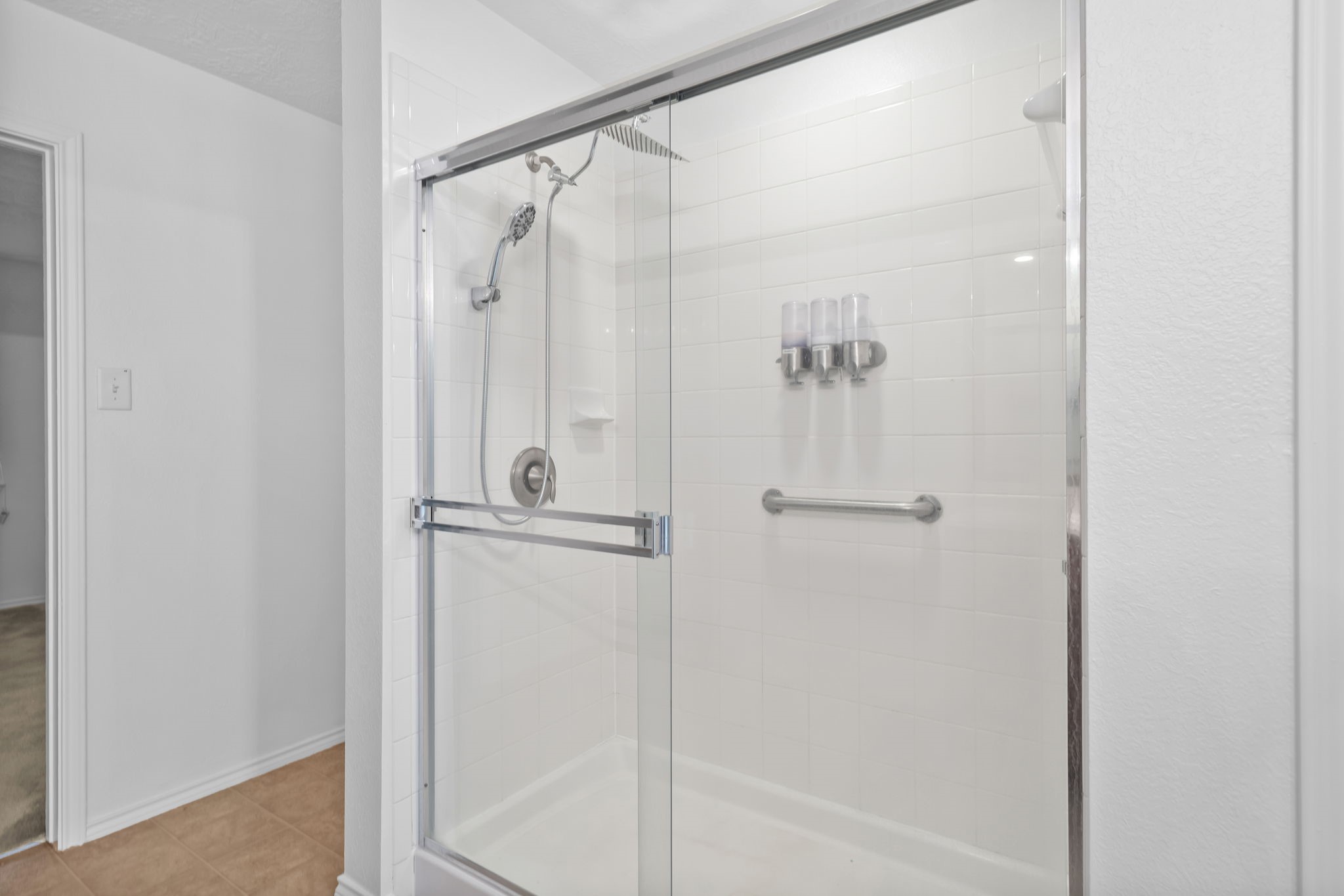 2810 Legends Knoll Drive Spring, TX 77386 - Photo 20 of 29 a bathroom with a glass shower door