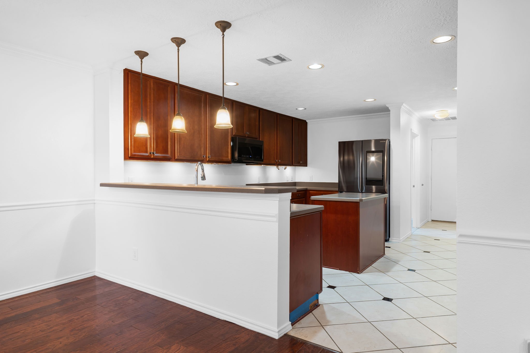 2810 Legends Knoll Drive Spring, TX 77386 - Photo 7 of 29 a kitchen with stainless steel appliances kitchen island granite countertop a refrigerator and a stove top oven
