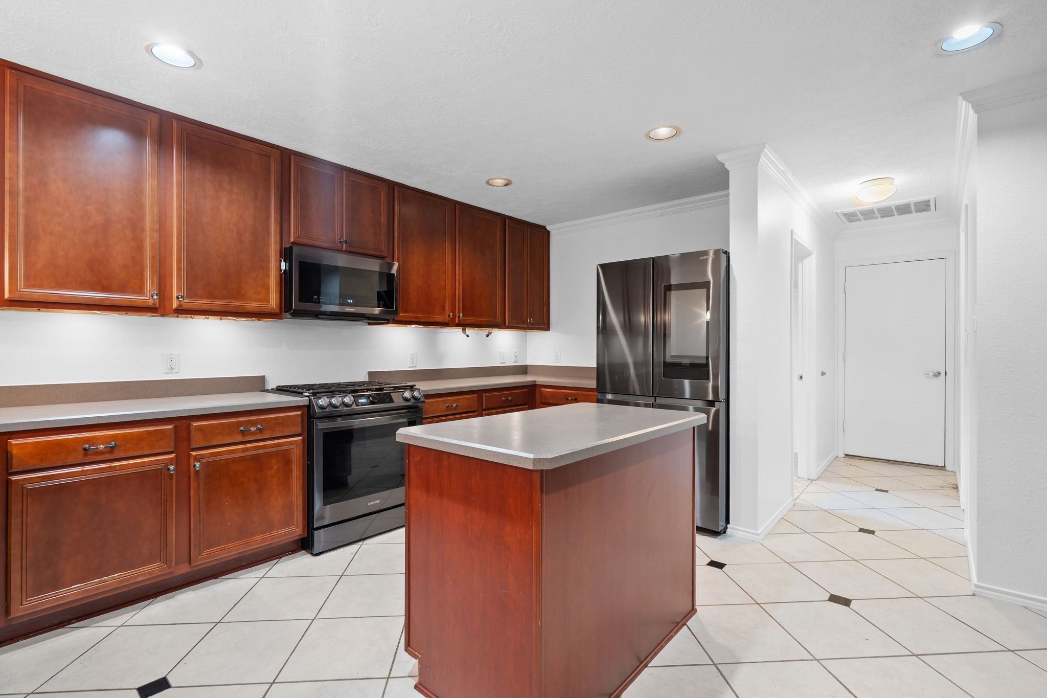 2810 Legends Knoll Drive Spring, TX 77386 - Photo 8 of 29 a kitchen with stainless steel appliances granite countertop a stove top oven a sink dishwasher and a refrigerator with wooden cabinets