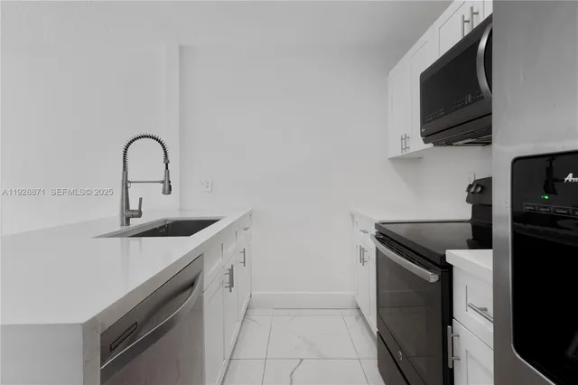 a kitchen with a sink and a stove top oven