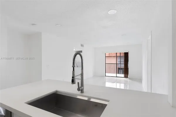 a close view of a sink a faucet and a window in a room