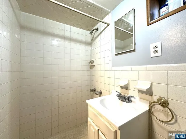 a bathroom with a sink mirror and toilet