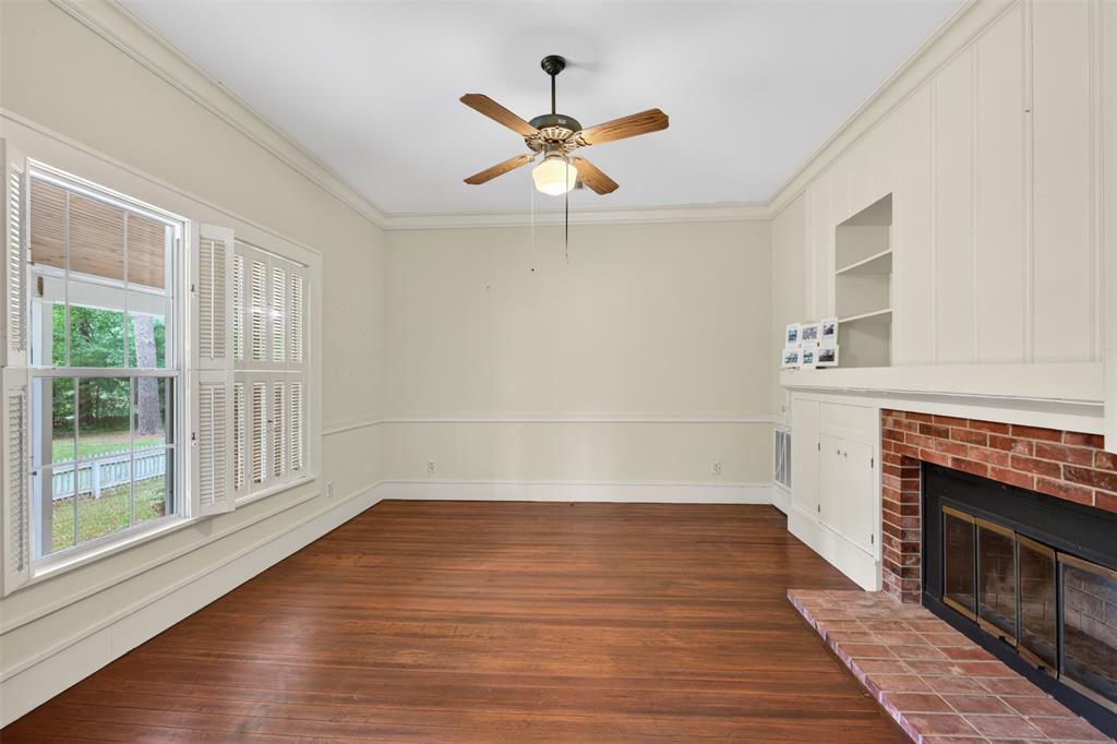 8402 Springridge-Texas Line Road Keithville, LA 71047 - Photo 11 of 40 a view of empty room with wooden floor and fireplace