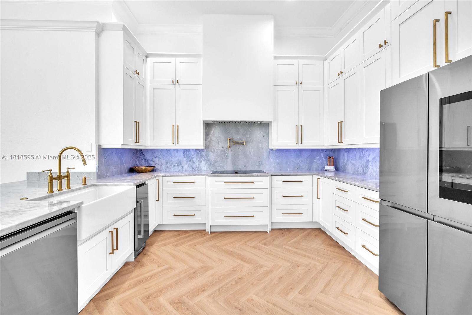 5478 Southwest 189th Avenue Miramar, FL 33029 - Photo 14 of 58 a kitchen with white cabinets and stainless steel appliances
