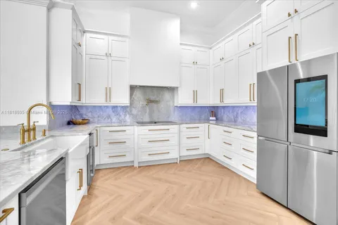 a kitchen with stainless steel appliances a refrigerator and a stove top oven