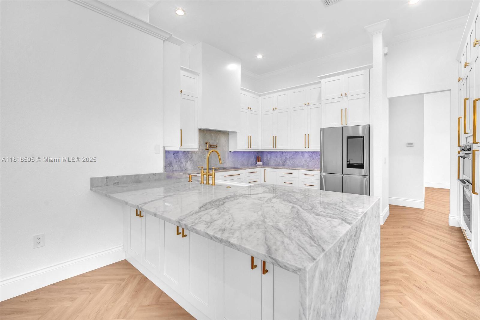 5478 Southwest 189th Avenue Miramar, FL 33029 - Photo 21 of 58 a kitchen with stainless steel appliances granite countertop a sink refrigerator and cabinets