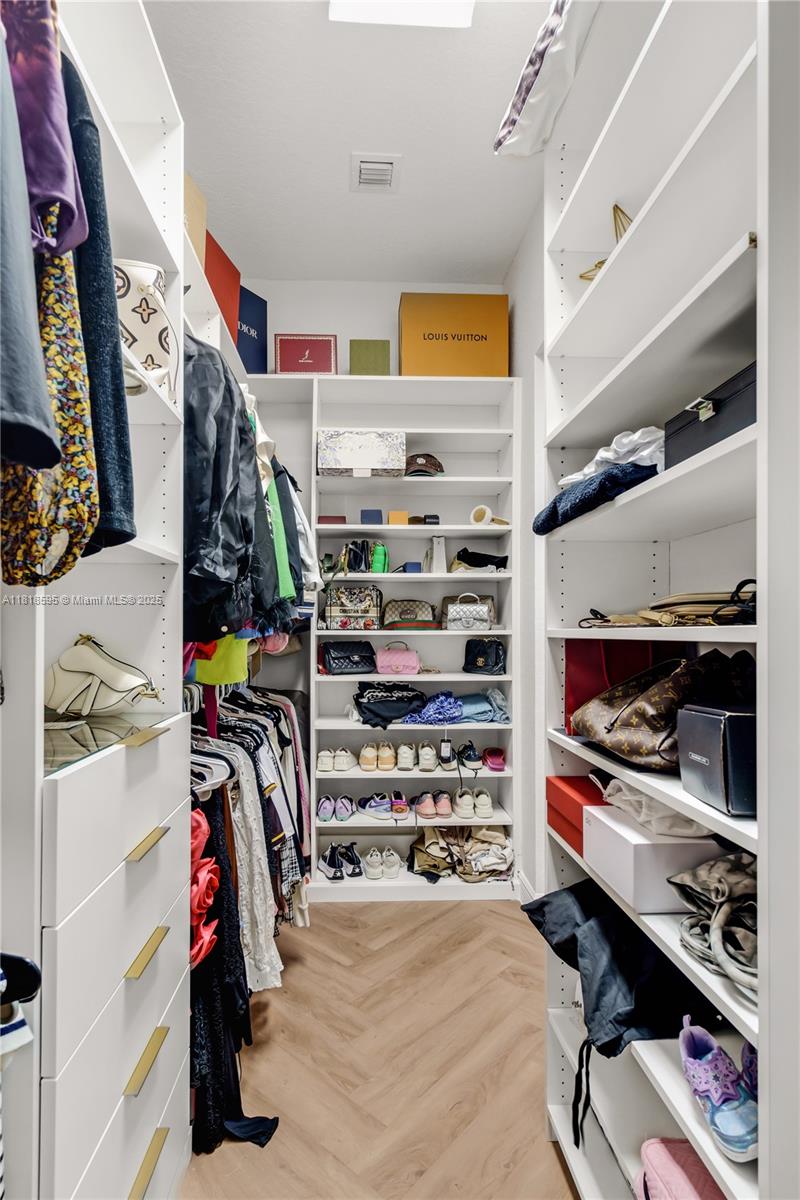 5478 Southwest 189th Avenue Miramar, FL 33029 - Photo 31 of 58 a view of walk in closet with clothes and shoes