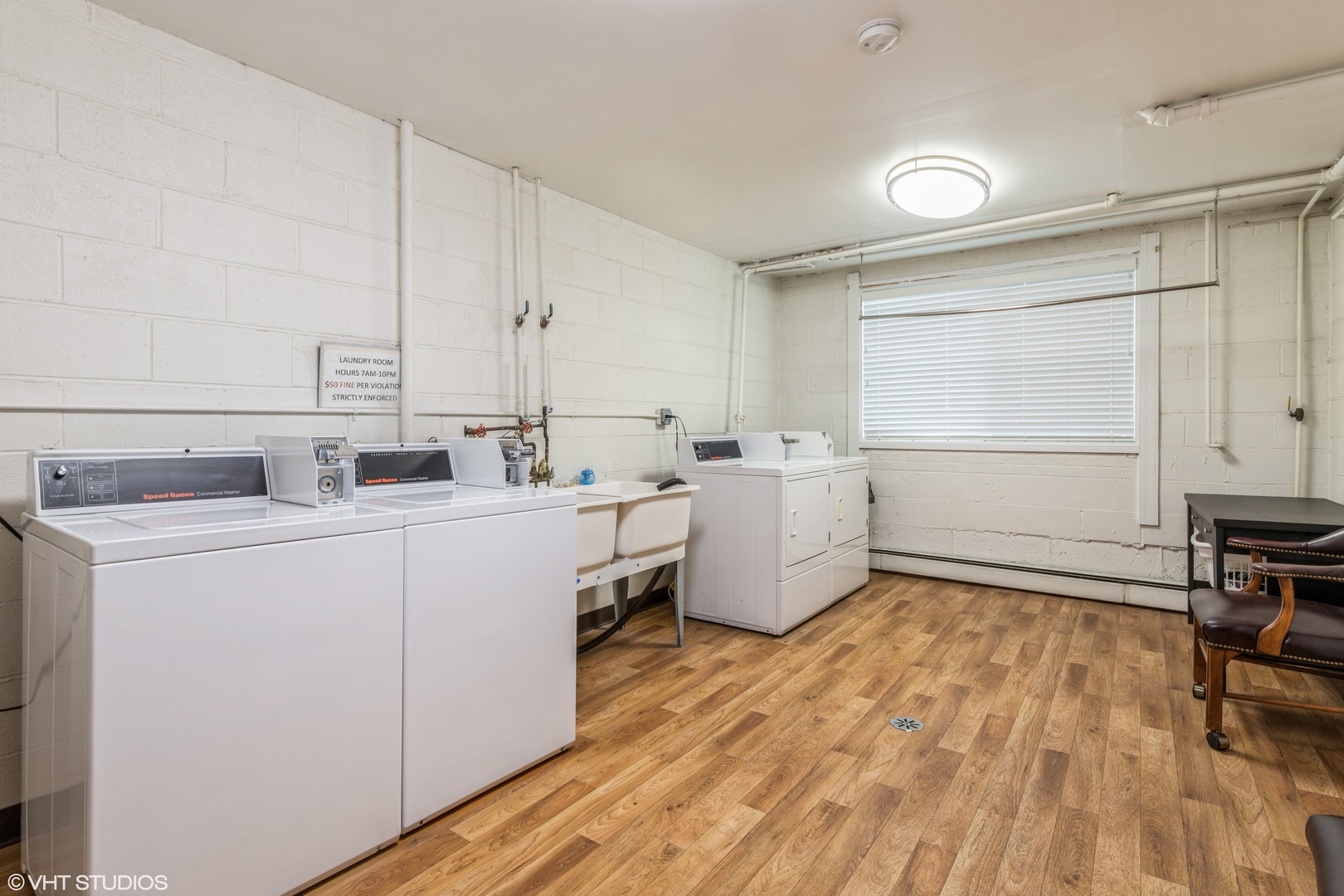 627 Ridge Road, Unit 401 Wilmette, IL 60091 - Photo 11 of 12 a room with a sink wooden floor and cabinets