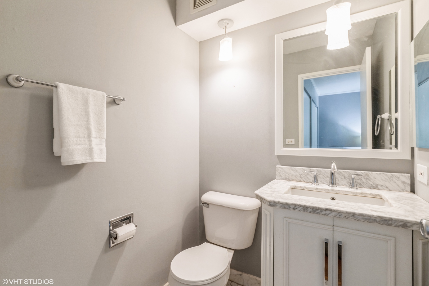 627 Ridge Road, Unit 401 Wilmette, IL 60091 - Photo 12 of 12 a bathroom with a granite countertop toilet sink and mirror