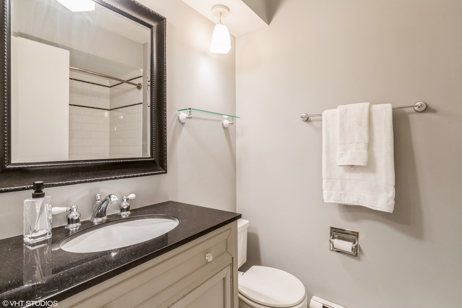 627 Ridge Road, Unit 401 Wilmette, IL 60091 - Photo 10 of 12 a bathroom with a granite countertop sink toilet and mirror