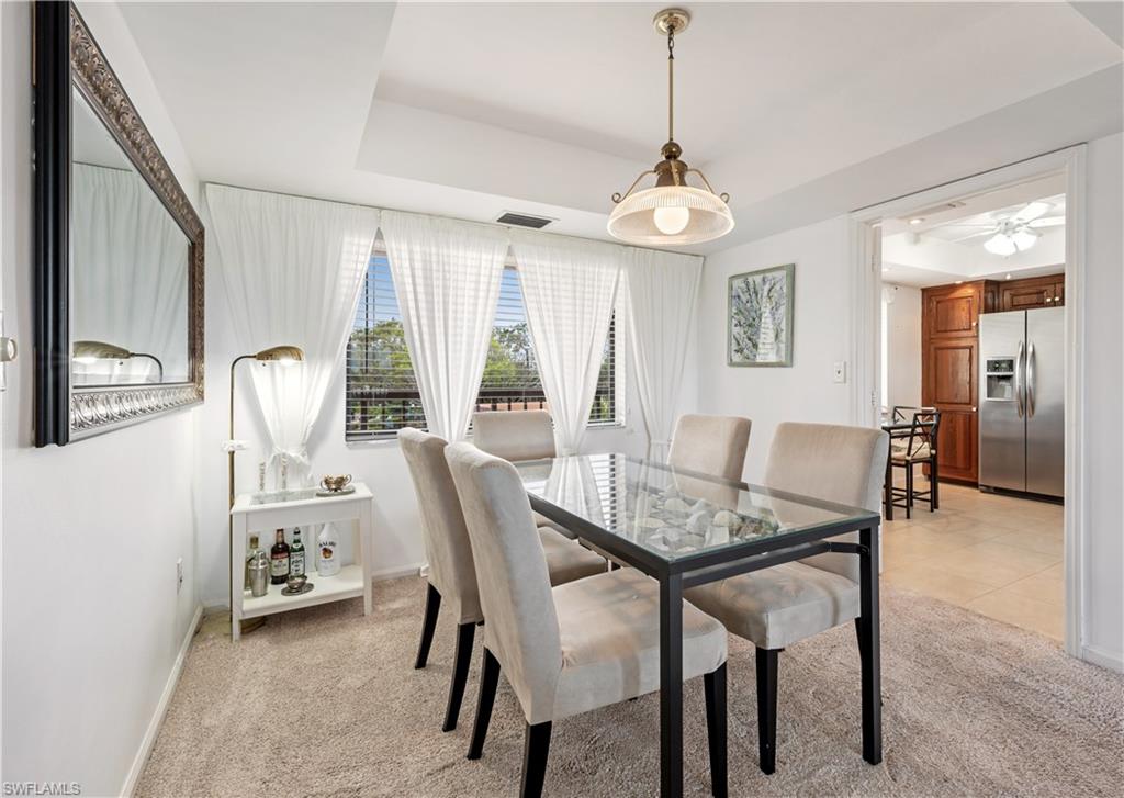 415 Augusta Boulevard, Unit 307 Naples, FL 34113 - Photo 11 of 36 a dining room with furniture and window
