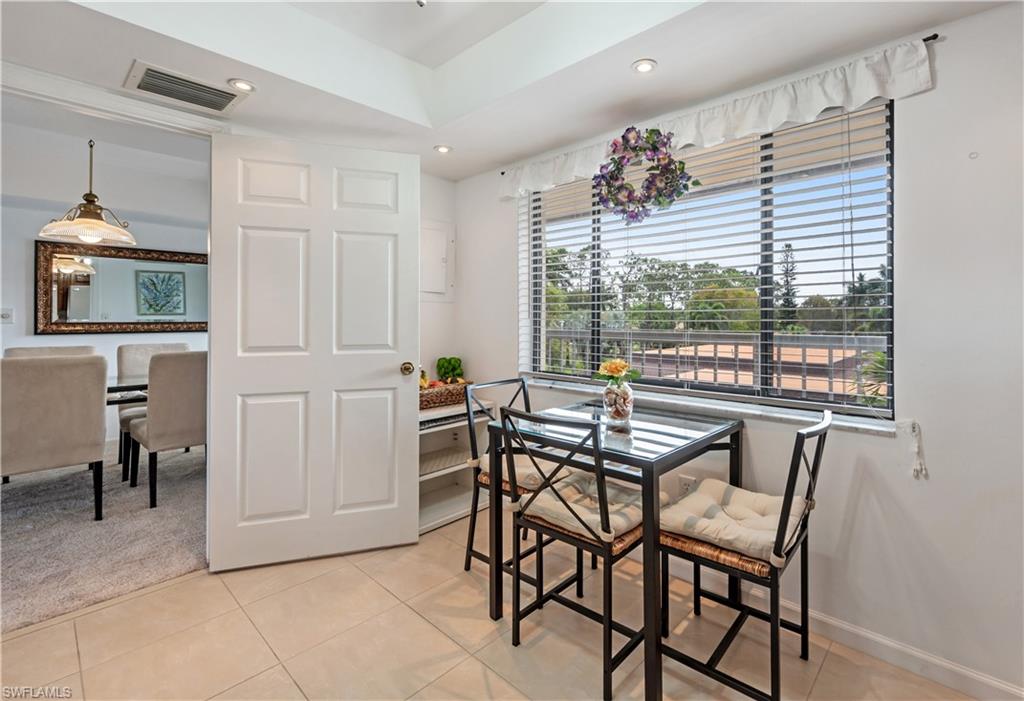 415 Augusta Boulevard, Unit 307 Naples, FL 34113 - Photo 14 of 36 a dining room with furniture and window