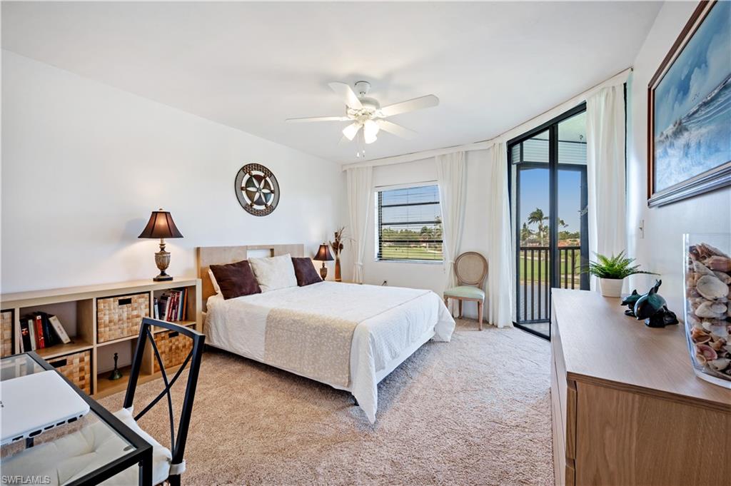 415 Augusta Boulevard, Unit 307 Naples, FL 34113 - Photo 15 of 36 a bedroom with a bed a bookshelf and a window