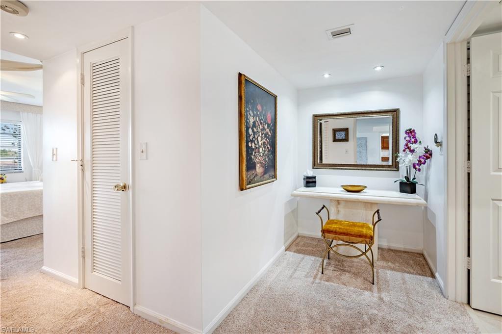 415 Augusta Boulevard, Unit 307 Naples, FL 34113 - Photo 19 of 36 a living room with furniture and a table