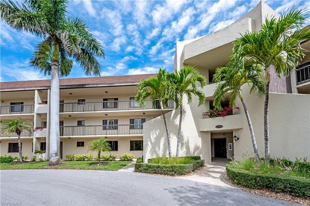 415 Augusta Boulevard, Unit 307 Naples, FL 34113 - Photo 2 of 36 a front view of multiple houses with outdoor seating