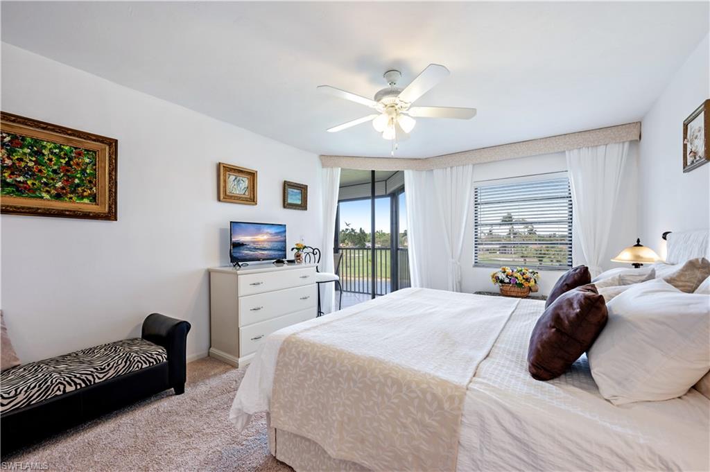 415 Augusta Boulevard, Unit 307 Naples, FL 34113 - Photo 21 of 36 a bedroom with a bed a couch and dresser