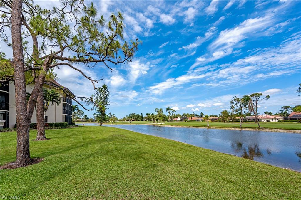 415 Augusta Boulevard, Unit 307 Naples, FL 34113 - Photo 30 of 36 a view of a lake with houses in the back