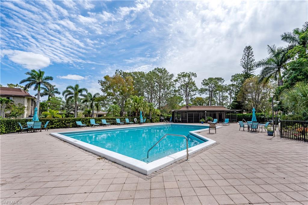 415 Augusta Boulevard, Unit 307 Naples, FL 34113 - Photo 33 of 36 swimming pool view with a seating space
