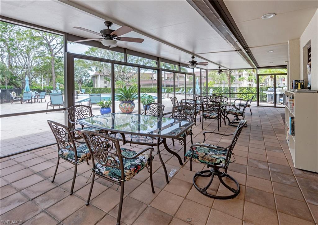 415 Augusta Boulevard, Unit 307 Naples, FL 34113 - Photo 35 of 36 a view of a dining room with furniture large windows and chairs