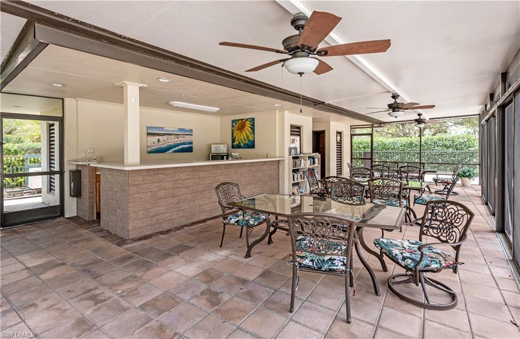 415 Augusta Boulevard, Unit 307 Naples, FL 34113 - Photo 36 of 36 a view of a dining room with furniture window and outside view