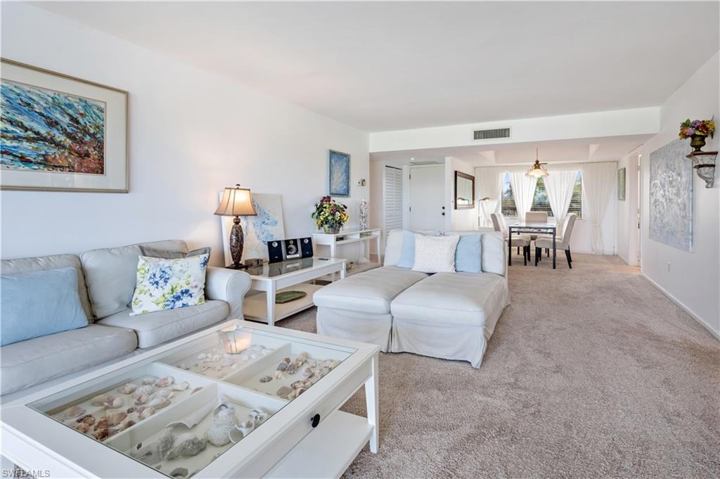415 Augusta Boulevard, Unit 307 Naples, FL 34113 - Photo 9 of 36 a living room with furniture and a couch