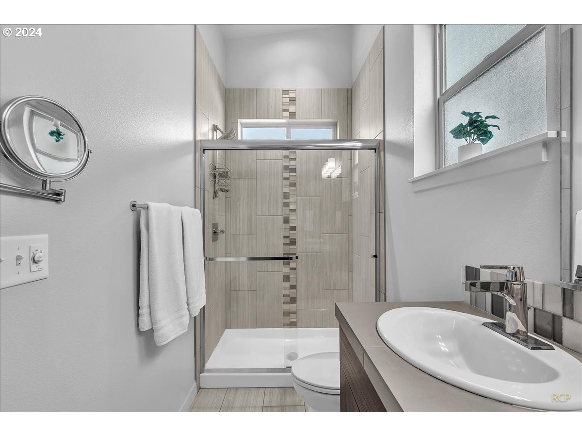14465 Southwest Aiken Lane Beaverton, OR 97005 - Photo 15 of 30 a bathroom with a sink vanity and a mirror