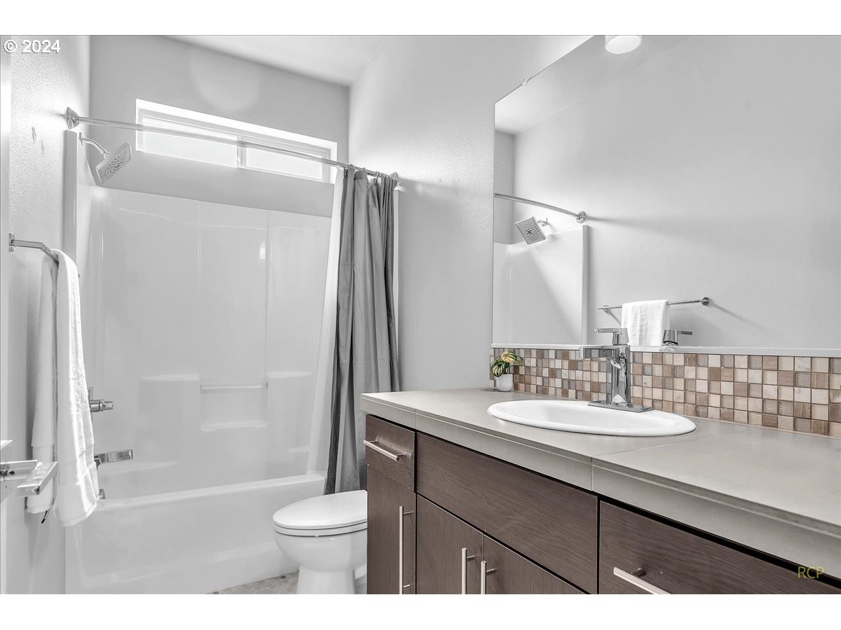 14465 Southwest Aiken Lane Beaverton, OR 97005 - Photo 22 of 30 a bathroom with a sink toilet a mirror and shower