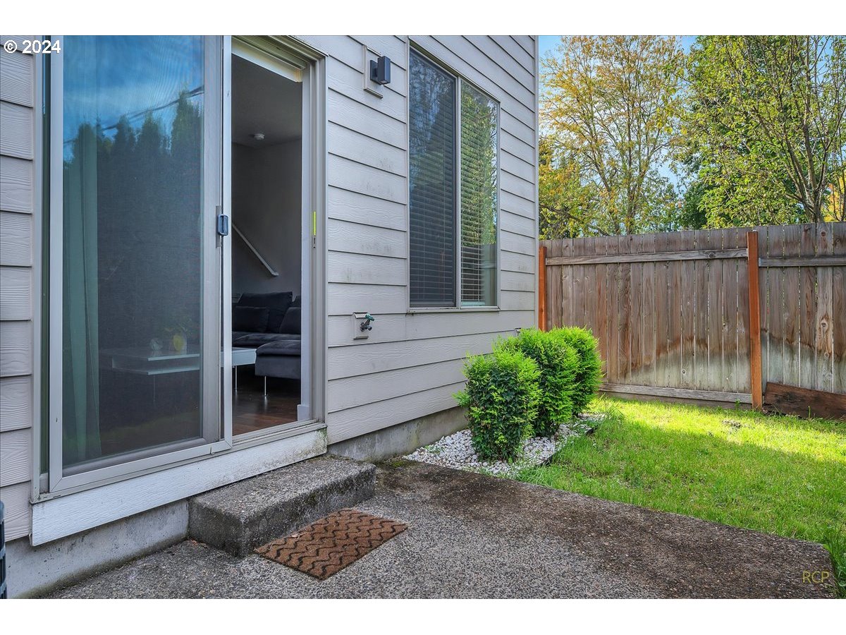 14465 Southwest Aiken Lane Beaverton, OR 97005 - Photo 25 of 30 a backyard of a house with potted plants and wooden fence
