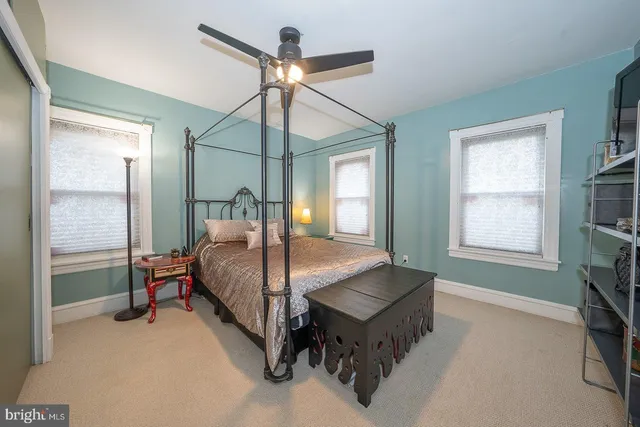 a bedroom with a bed table and chair