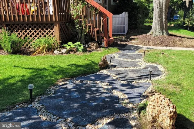 a view of a backyard with plants and patio