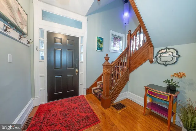 a bedroom with furniture and a wooden floor