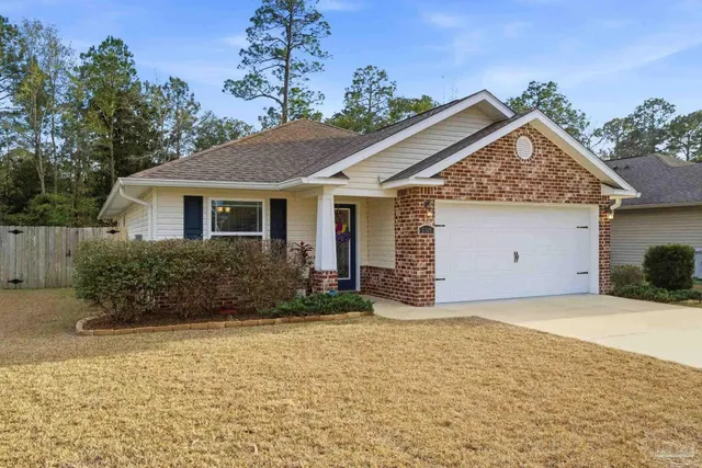 a view of a house with a yard and potted plants
