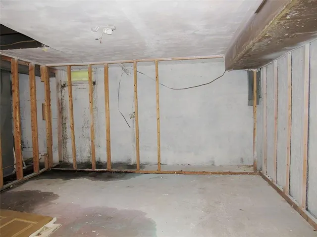 an empty room with a wooden floor and a window