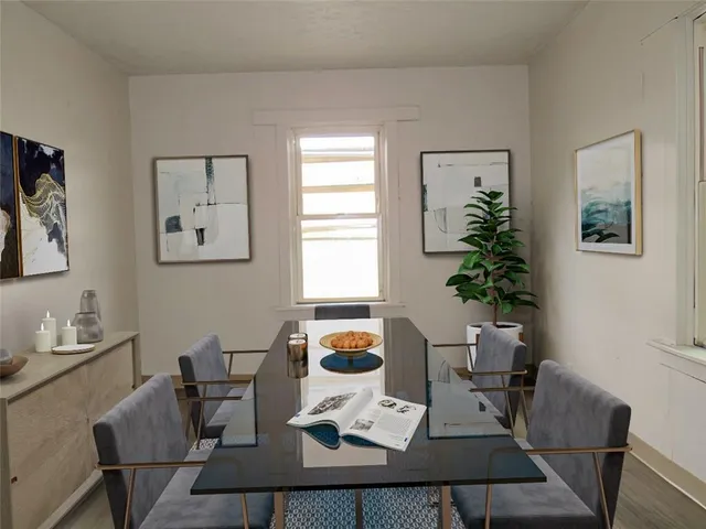 a view of a dining room with furniture window and wooden floor