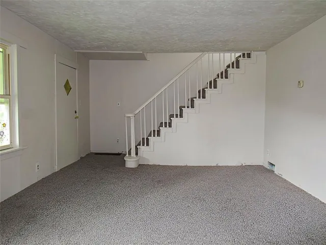 a view of an empty room with stairs