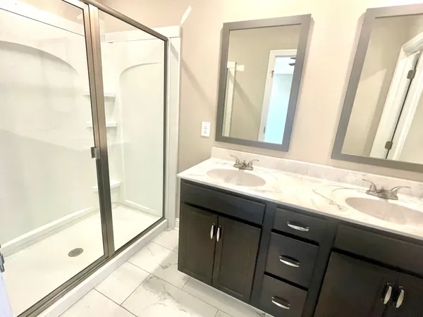 a bathroom with a double vanity sink and a mirror