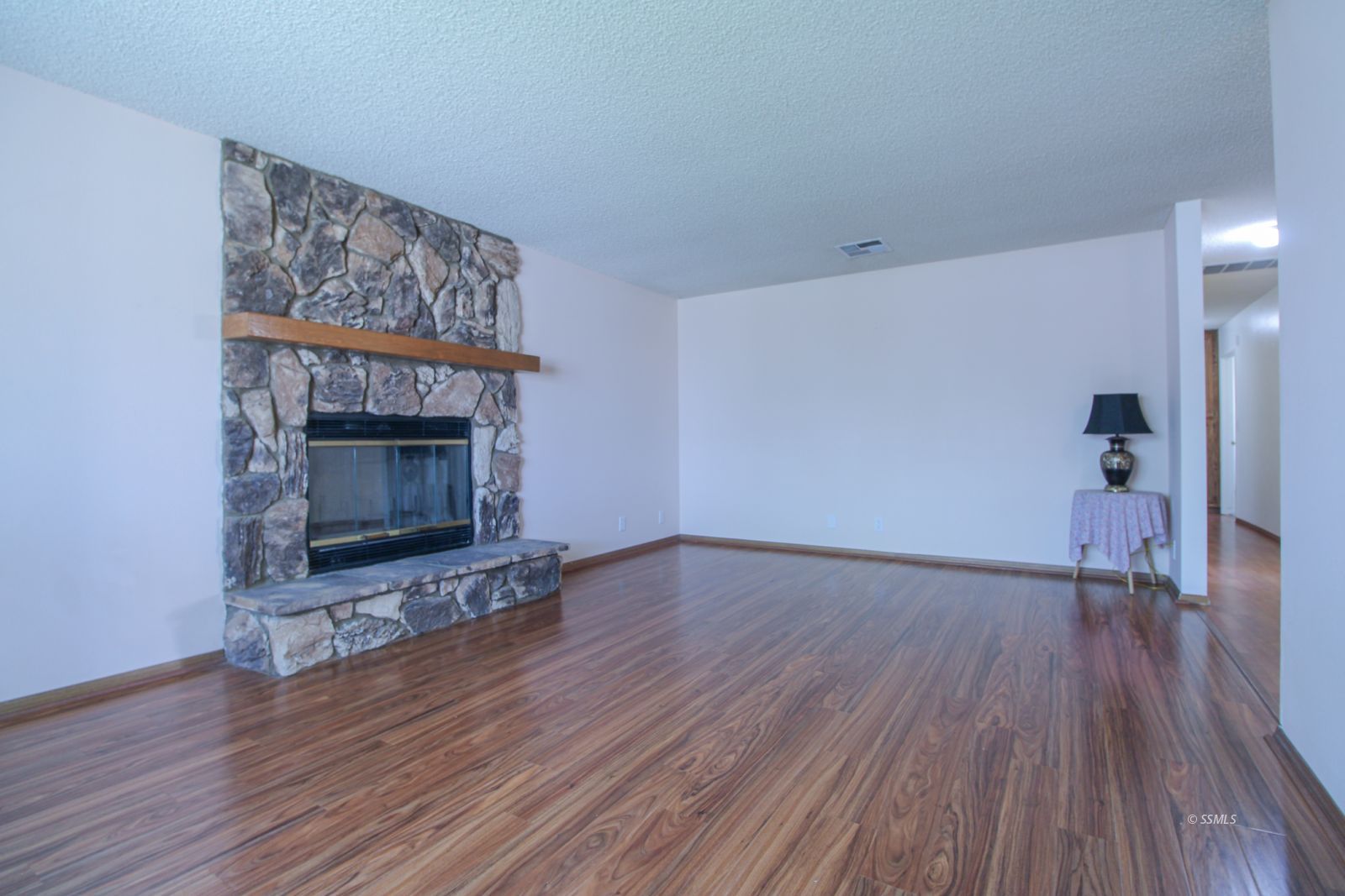 609 South Appaloosa Street Ridgecrest, CA 93555 - Photo 7 of 44 a view of empty room with wooden floor and fireplace