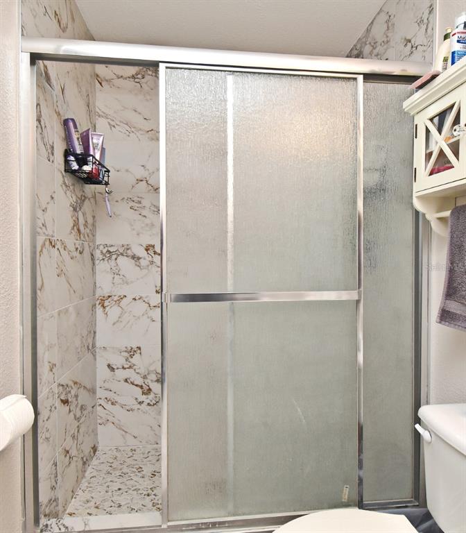 700 Seabrook Court, Unit 102 Altamonte Springs, FL 32714 - Photo 12 of 22 a bathroom with a shower and a toilet in it