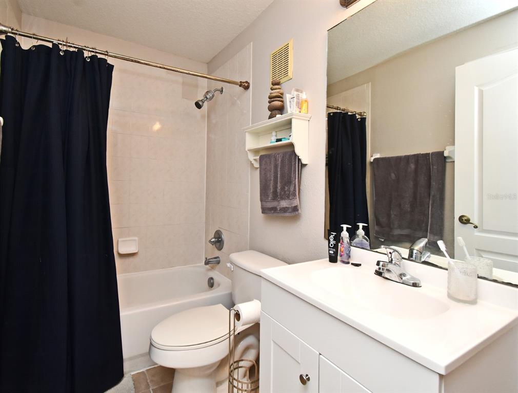 700 Seabrook Court, Unit 102 Altamonte Springs, FL 32714 - Photo 16 of 22 a bathroom with a granite countertop sink toilet and shower