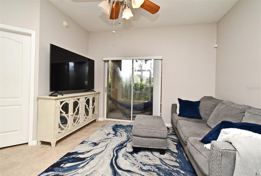 700 Seabrook Court, Unit 102 Altamonte Springs, FL 32714 - Photo 4 of 22 a living room with furniture and a flat screen tv