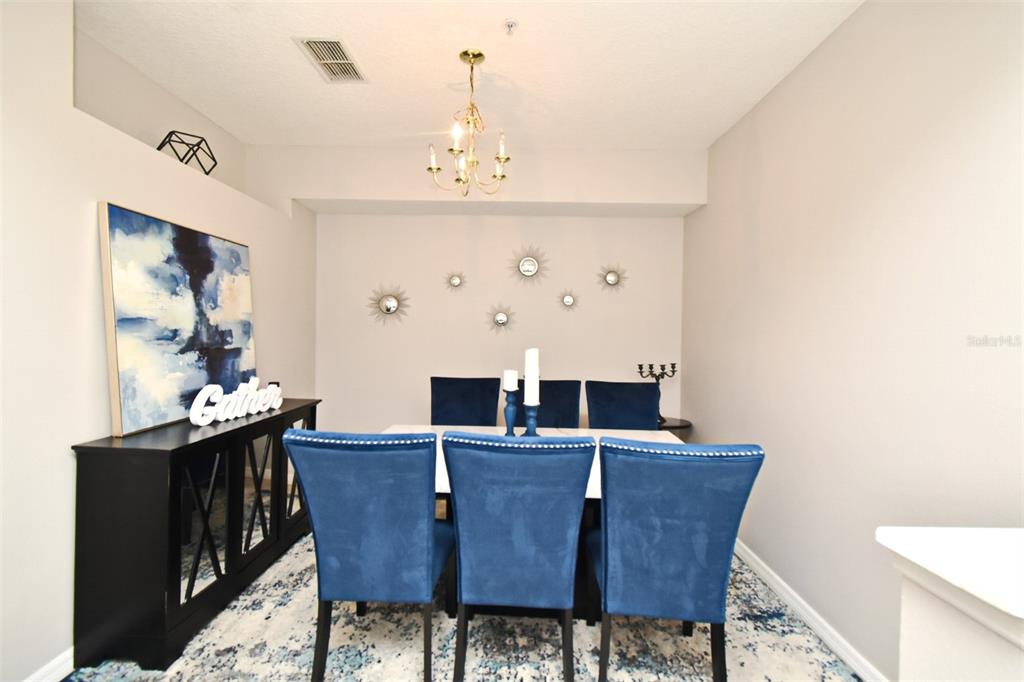 700 Seabrook Court, Unit 102 Altamonte Springs, FL 32714 - Photo 5 of 22 a view of a dining room with furniture and wooden floor
