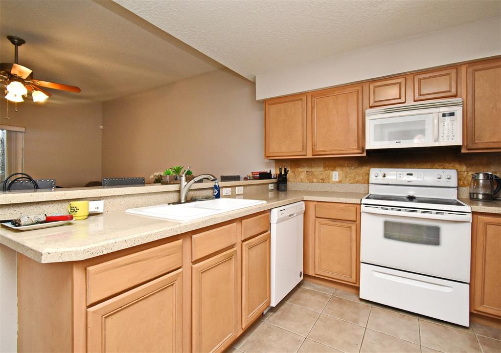 700 Seabrook Court, Unit 102 Altamonte Springs, FL 32714 - Photo 7 of 22 a kitchen with stainless steel appliances granite countertop a sink and cabinets