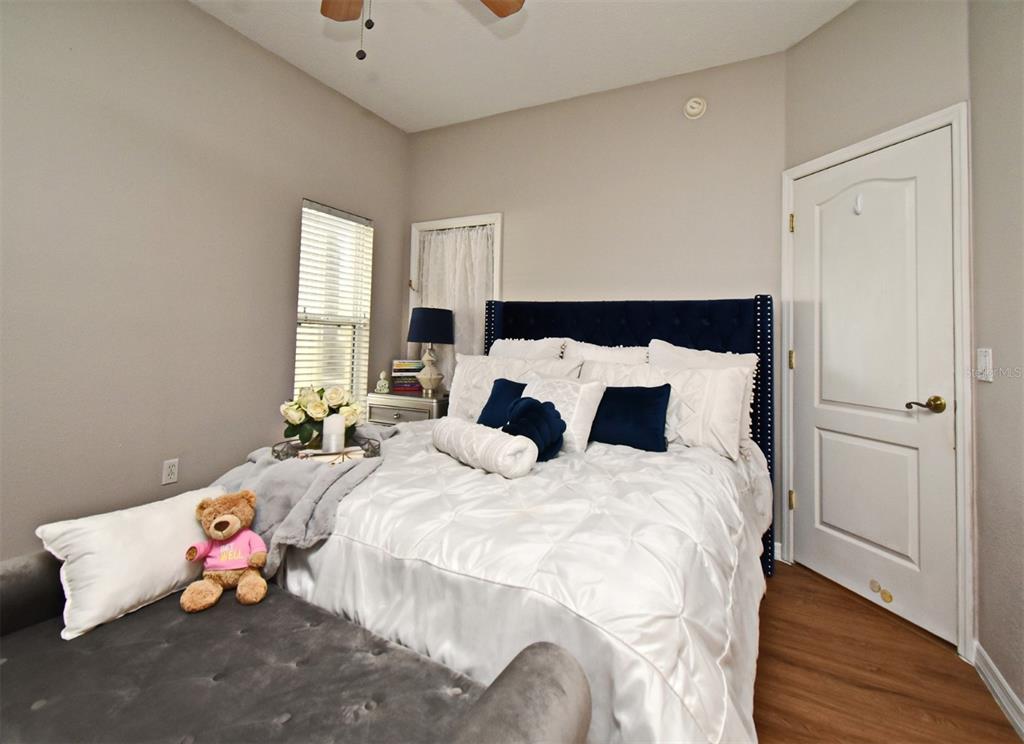 700 Seabrook Court, Unit 102 Altamonte Springs, FL 32714 - Photo 9 of 22 a bed sitting in a bedroom next to a window and a lamp