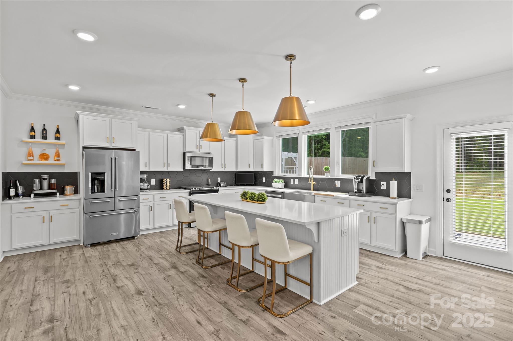 5902 Beatties Ford Road Charlotte, NC 28216 - Photo 11 of 48 a kitchen with kitchen island granite countertop a sink a counter top space and stainless steel appliances