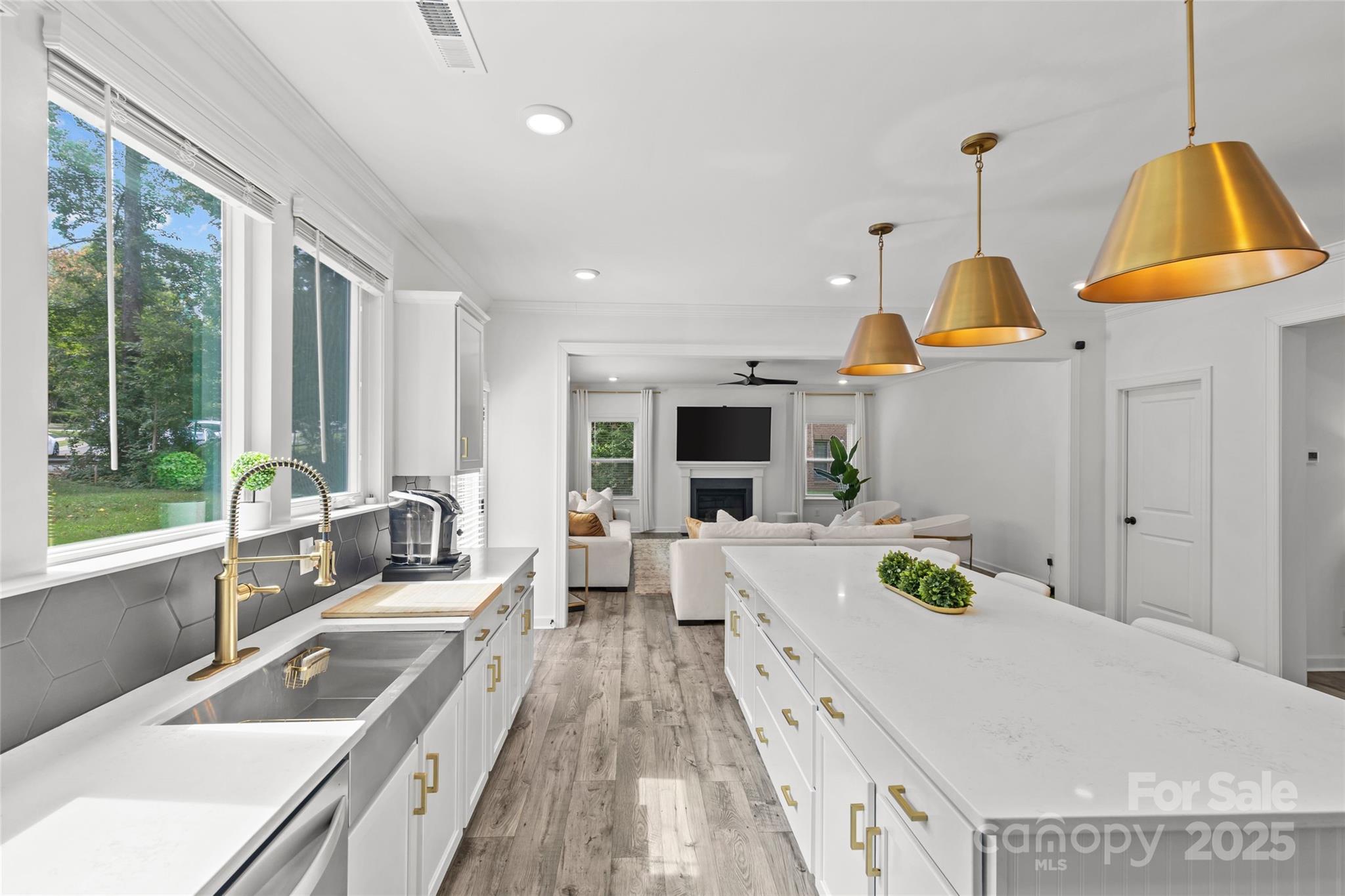 5902 Beatties Ford Road Charlotte, NC 28216 - Photo 12 of 48 a kitchen with a sink a counter top space and living room view