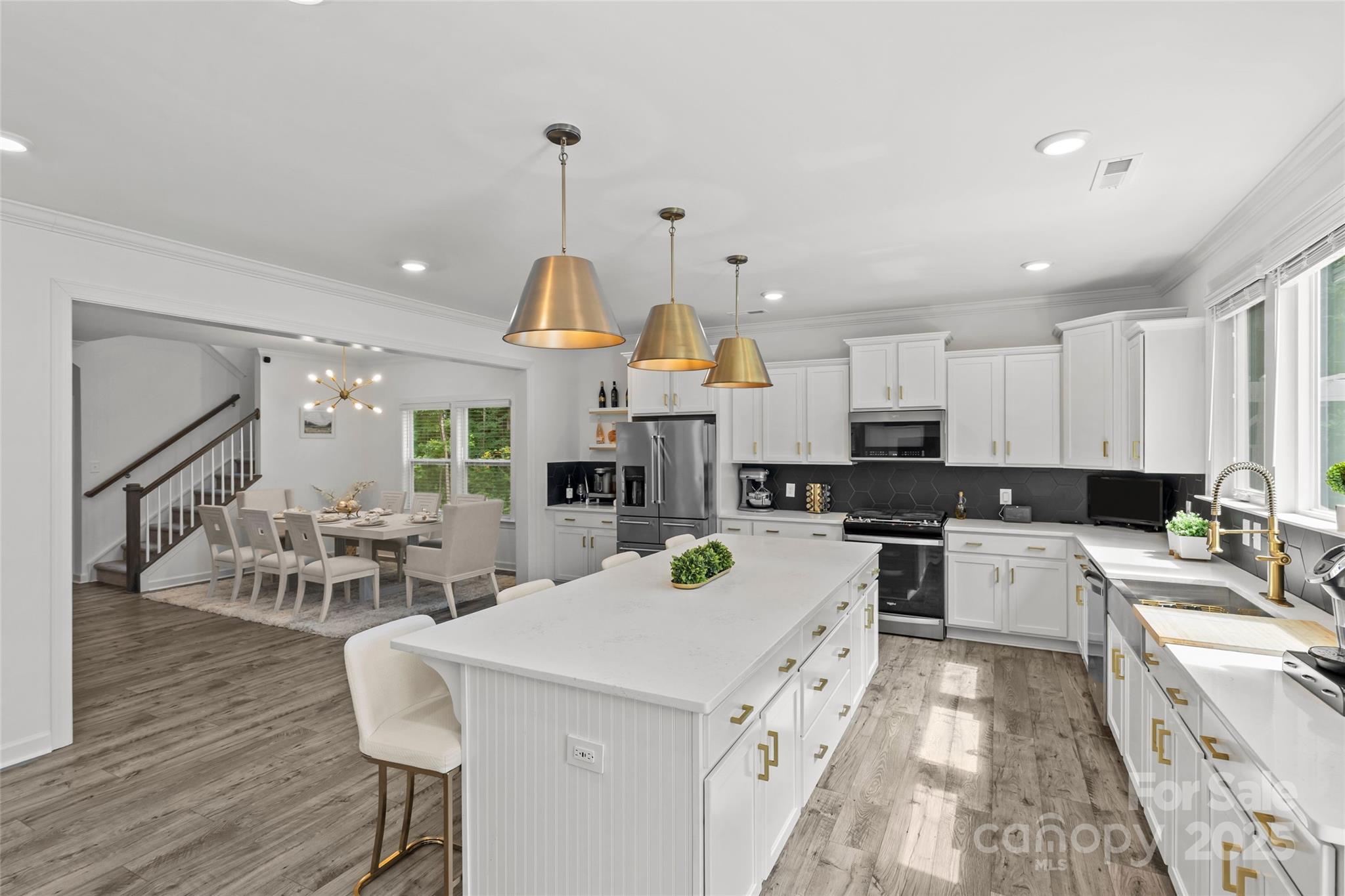 5902 Beatties Ford Road Charlotte, NC 28216 - Photo 14 of 48 a kitchen that has a lot of cabinets a sink and wooden floor