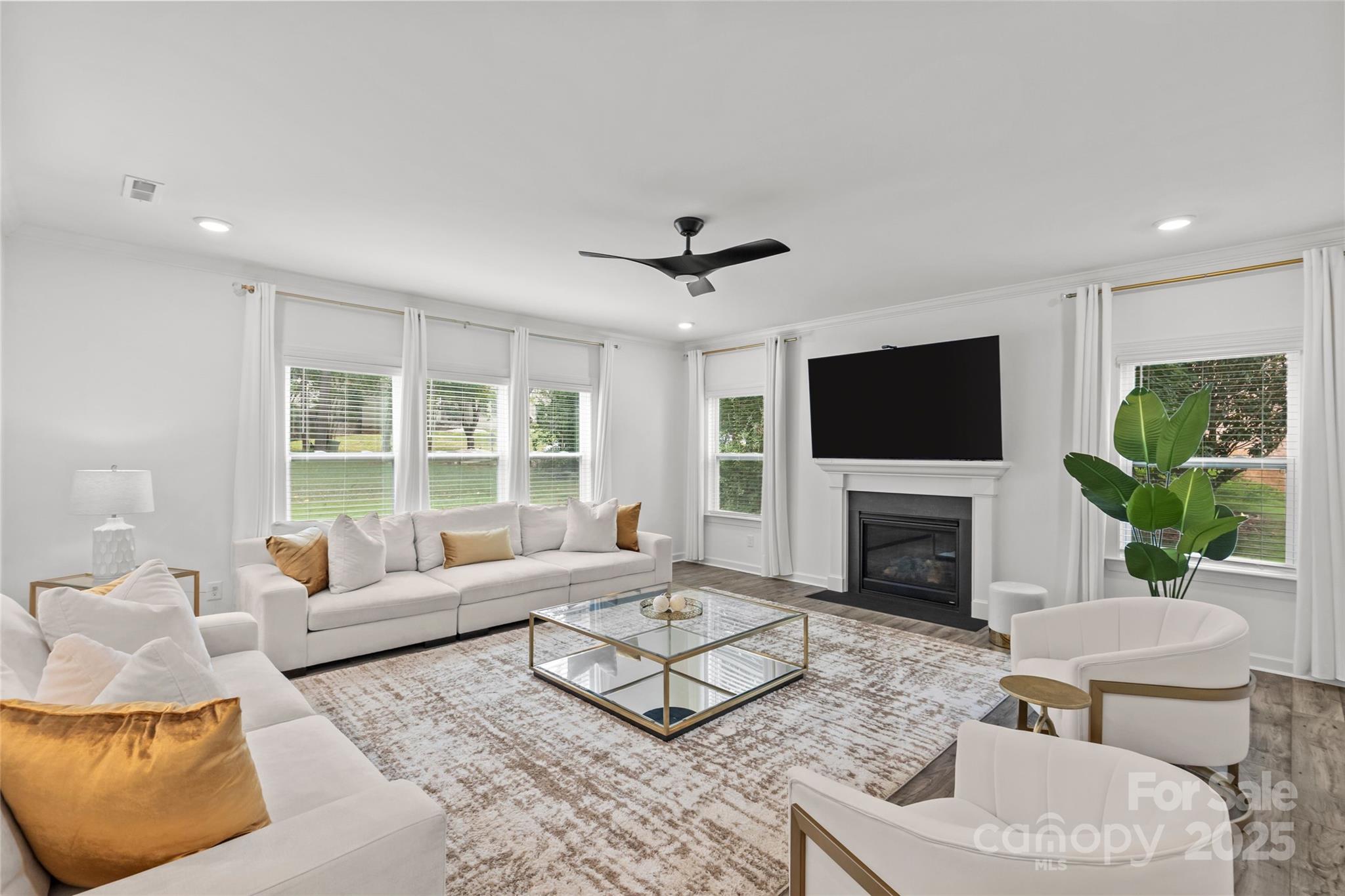 5902 Beatties Ford Road Charlotte, NC 28216 - Photo 18 of 48 a living room with furniture a fireplace and a flat screen tv