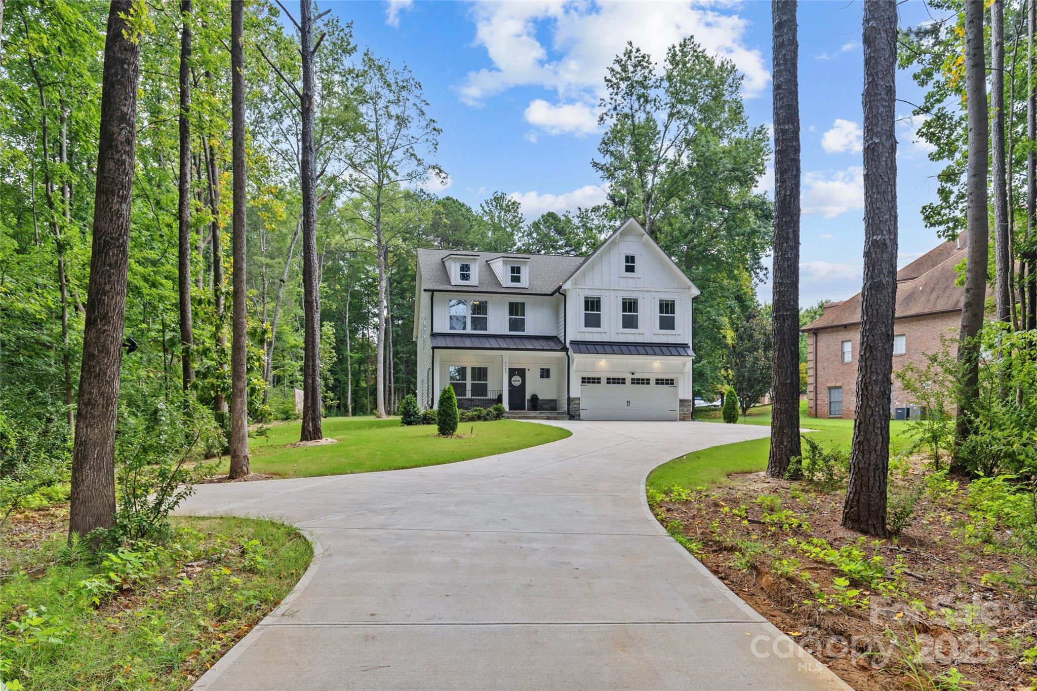 5902 Beatties Ford Road Charlotte, NC 28216 - Photo 2 of 48 a front view of a house with garden