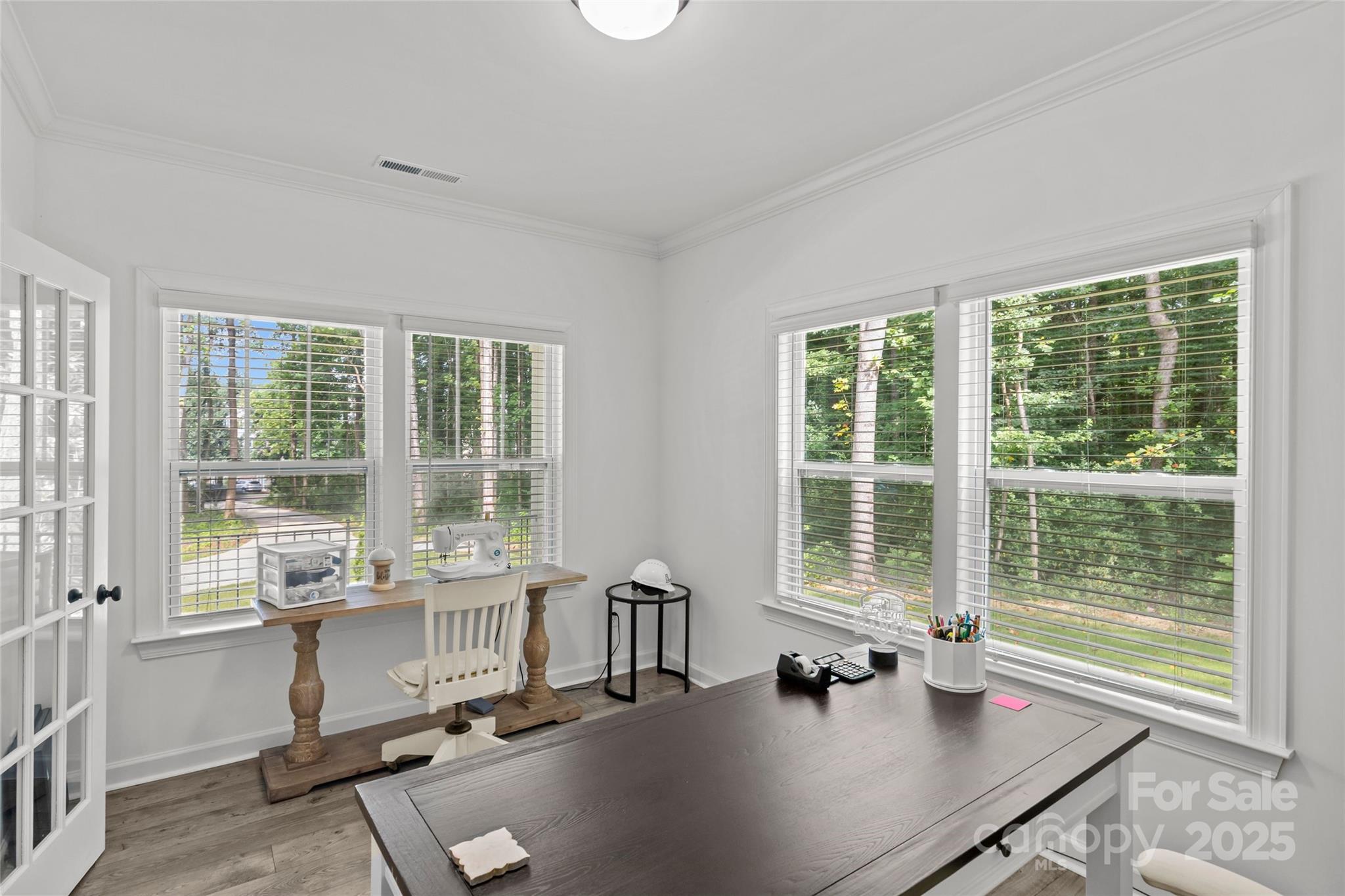 5902 Beatties Ford Road Charlotte, NC 28216 - Photo 23 of 48 a dining room with wooden floor and a window
